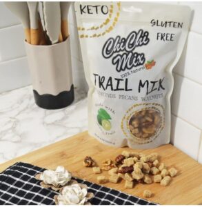 A white ChiChi Mix bag sits on a cutting board with a table cloth and ChiChi Mix in front