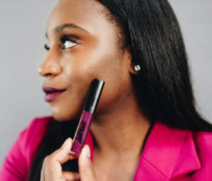 Courtney Wright, founder of LipRevolt and a black woman, wearing the company's Uproar lipstick