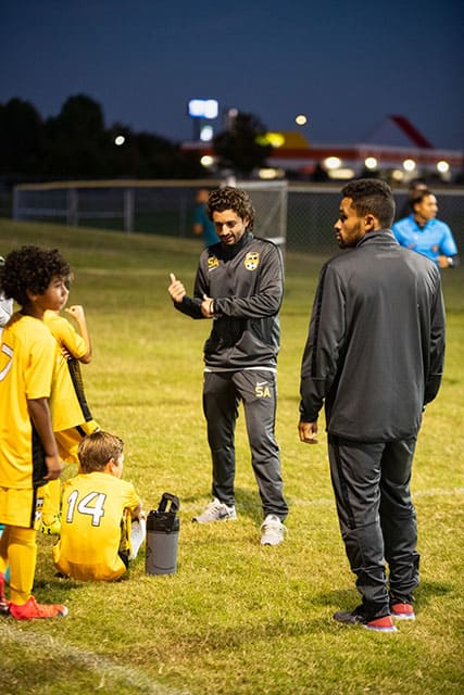 Sean on a soccer field teaching