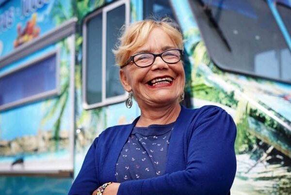 Entrepreneur smiling in front of her food truck