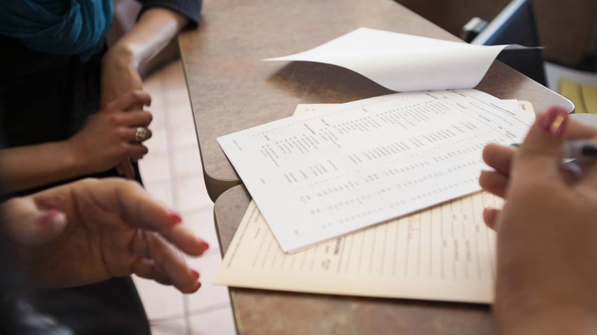 Close up of business owners' hands, who are discussing how to prepare a cash flow statement.