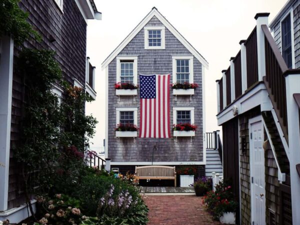 House with a large American flag hanging on the outside interior, possibly the home of a veteran with disabilities looking for small business loans.