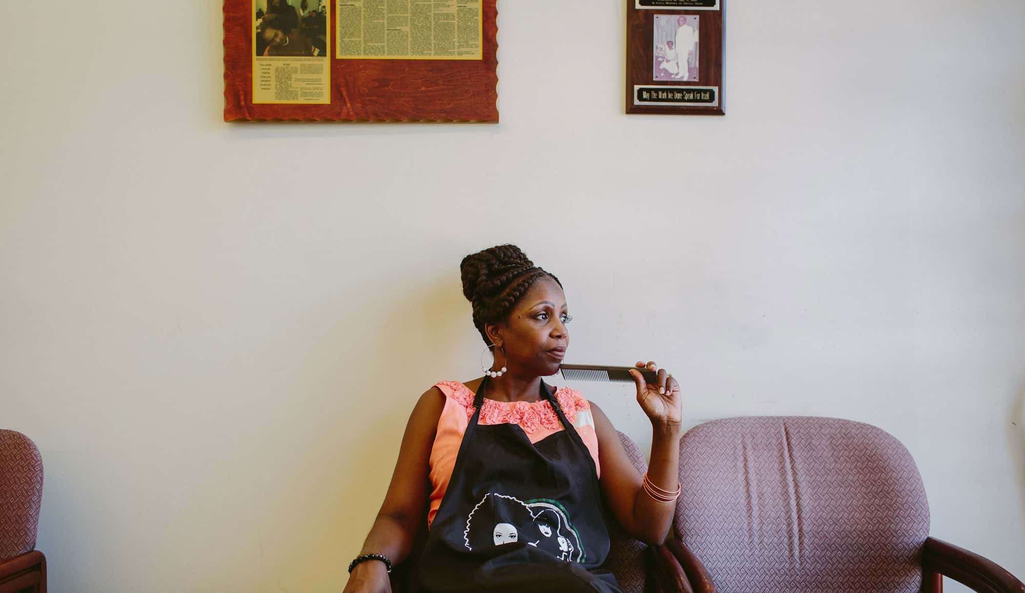 Female business owner holding a comb, considering options for minority business loans to fund her business