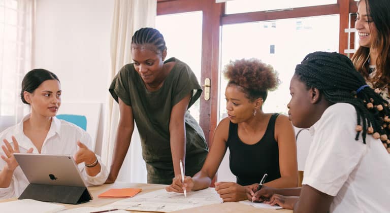 Group of female business owners discussing their loans for small business needs.